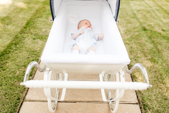 Amy Havins wears white denim and pushes Ralph in her silver cross stroller.