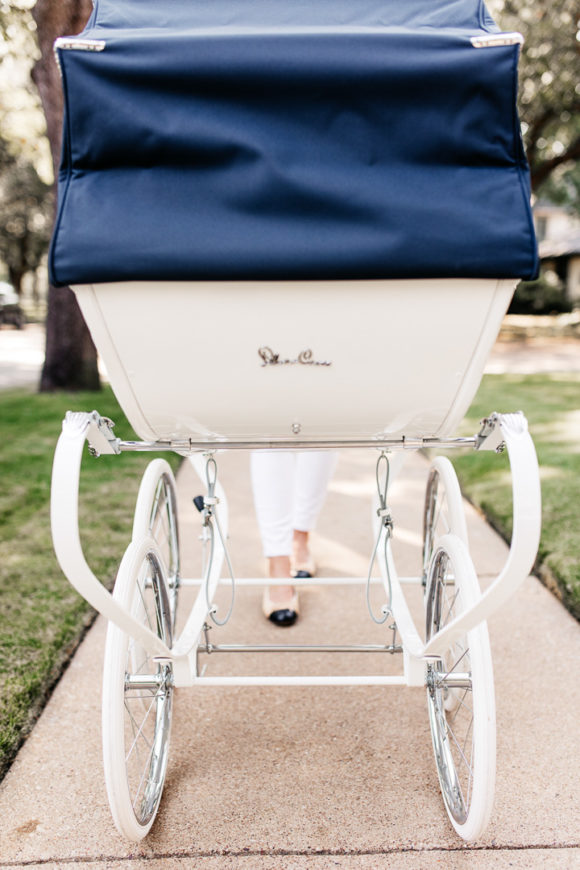 Amy Havins wears white denim and pushes Ralph in her silver cross stroller.