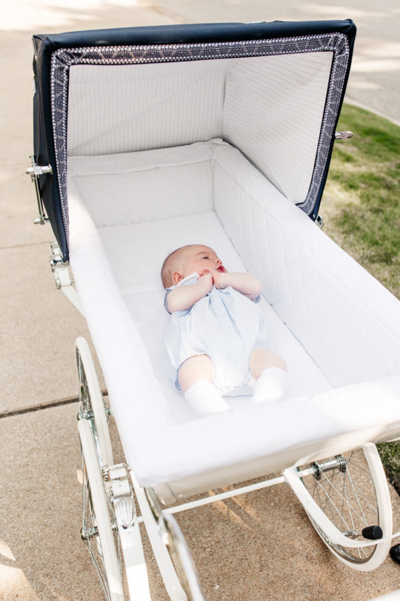 Amy Havins wears white denim and pushes Ralph in her silver cross stroller.