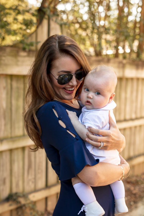 Amy Havins wears a navy shoshanna dress with baby ralph.