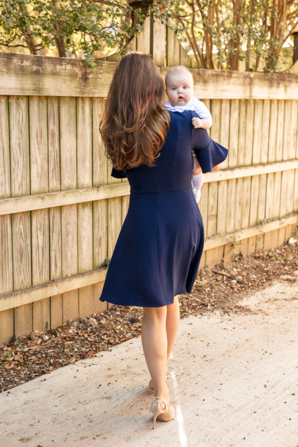 Amy Havins wears a navy shoshanna dress with baby ralph.