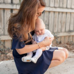 Amy Havins wears a navy shoshanna dress with baby ralph.