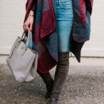 Amy Havins wears a poncho with stuart weitzman over the knee boots and jeans.