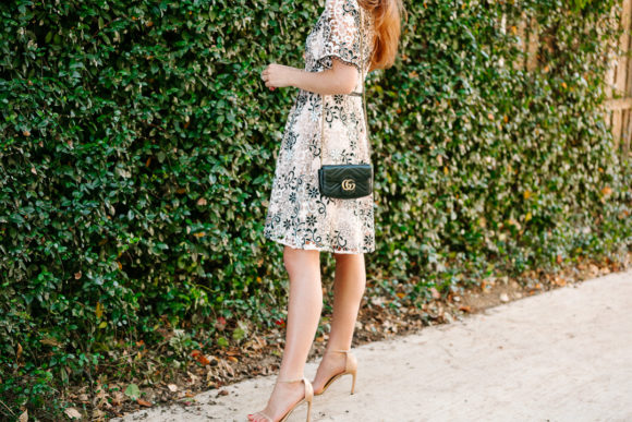 Amy Havins wears a blush and black lace dress.