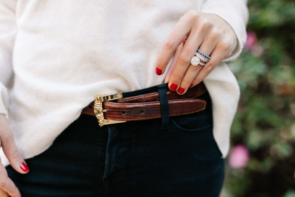 Amy Havins wears brown boots and a white sweater.