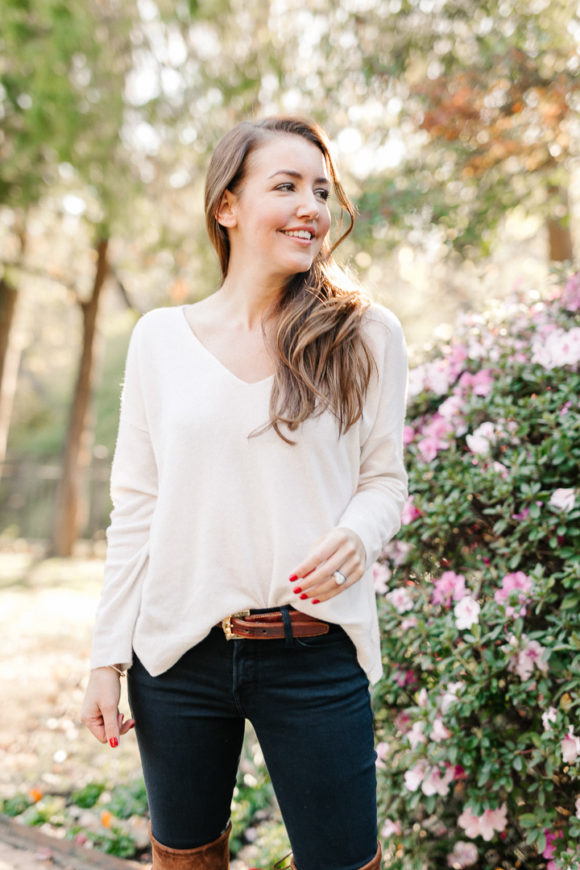 Amy Havins wears brown boots and a white sweater.