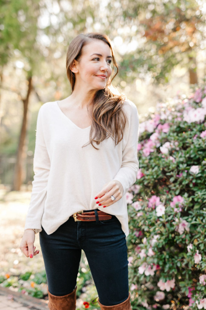 Amy Havins wears brown boots and a white sweater.