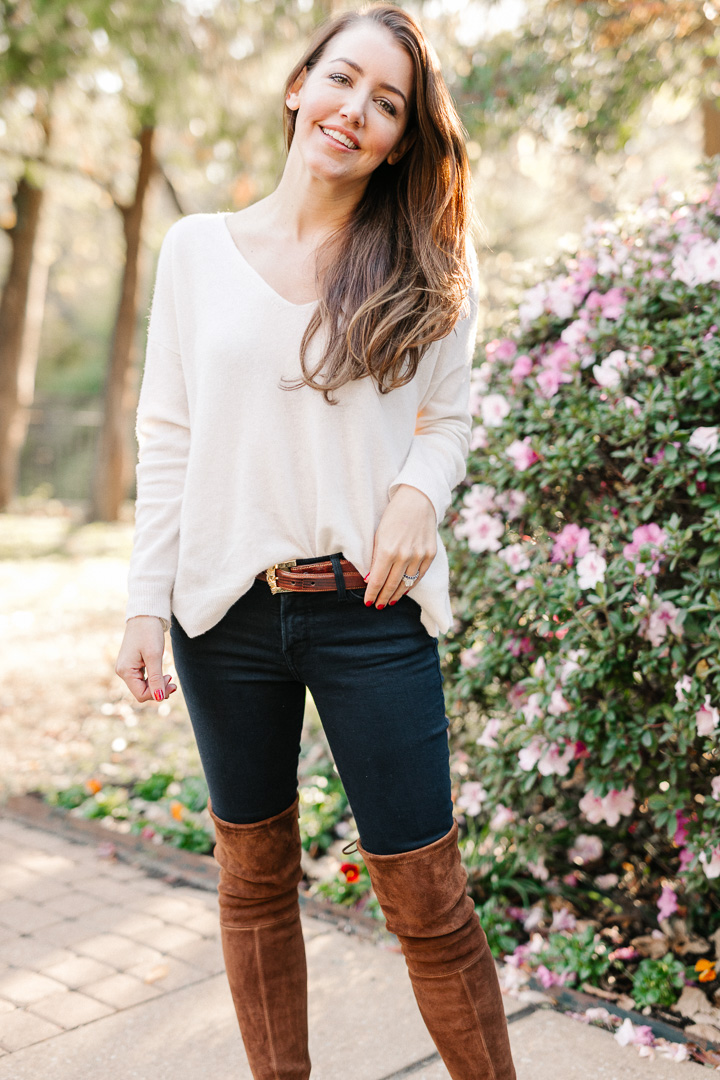 Amy Havins wears brown boots and a white sweater.
