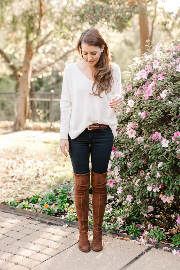 Amy Havins wears brown boots and a white sweater.