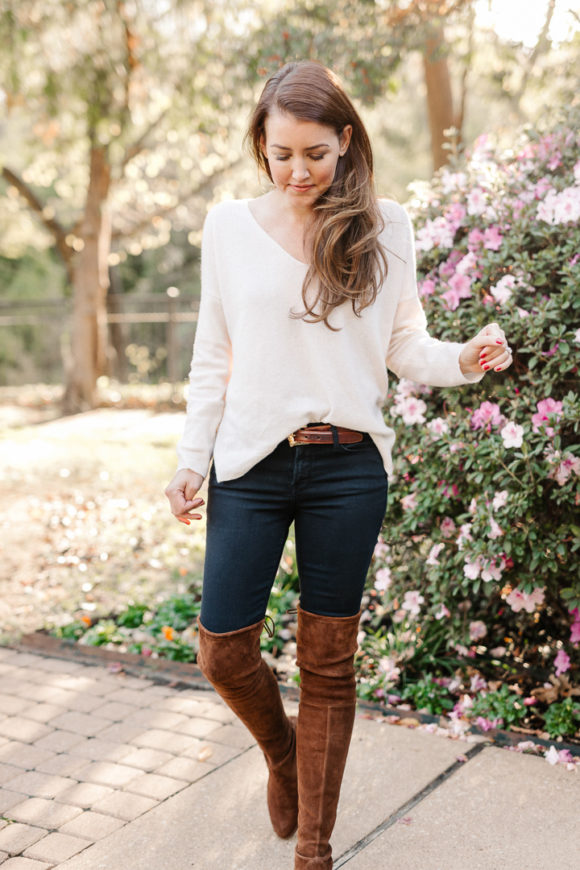 Amy Havins wears brown boots and a white sweater.