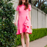 Amy Havins wears a spring pink shoshanna dress.