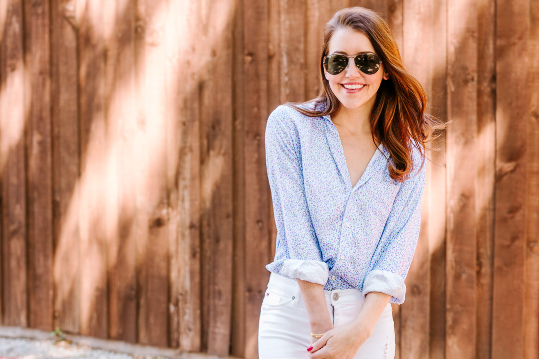 Amy Havins wears white jeans and a floral frank and eileen button down.