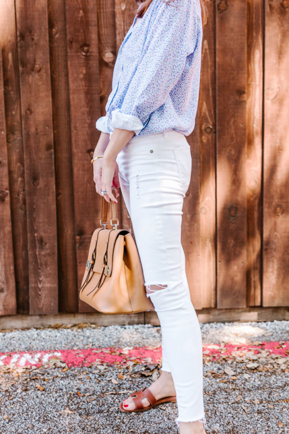 Amy Havins wears white jeans and a floral frank and eileen button down.