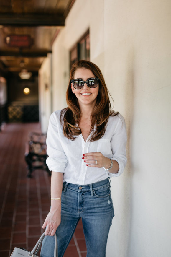Amy Havins wears a white blouse and jeans.