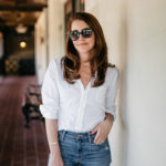 Amy Havins wears a white blouse and jeans.