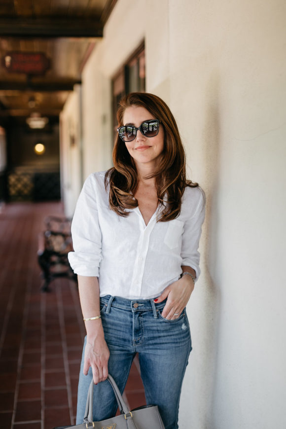 Amy Havins wears a white blouse and jeans.