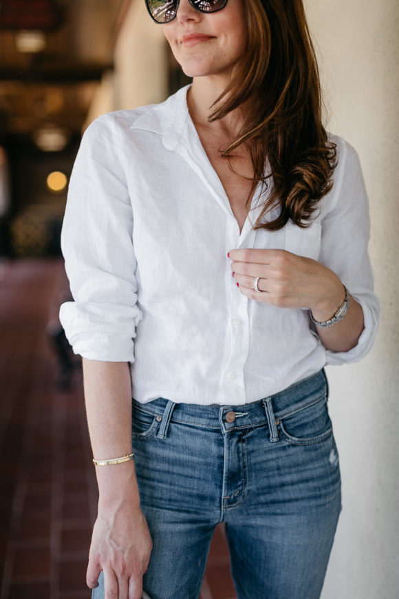 Amy Havins wears a white blouse and jeans.