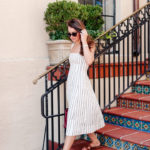 Amy Havins wears a theory stripe dress.