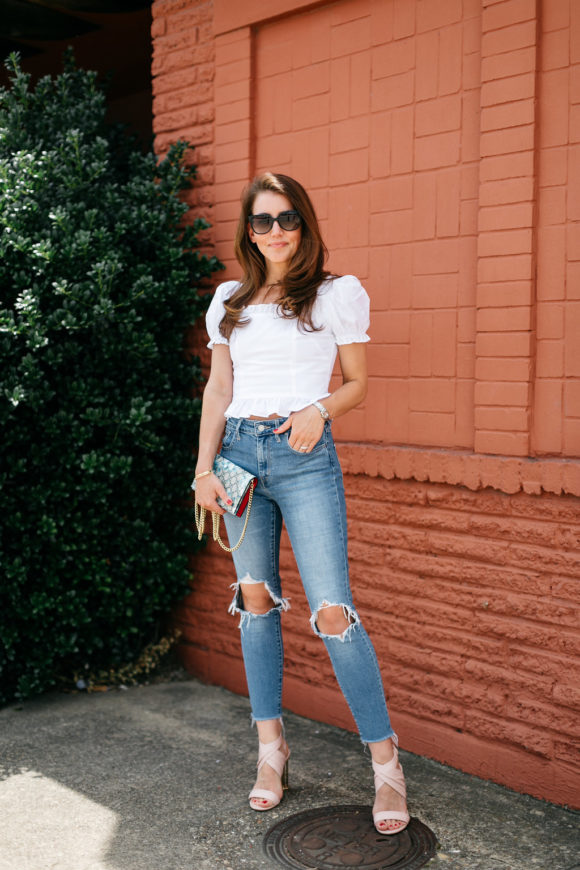 amy havins wears jeans and a white blouse.
