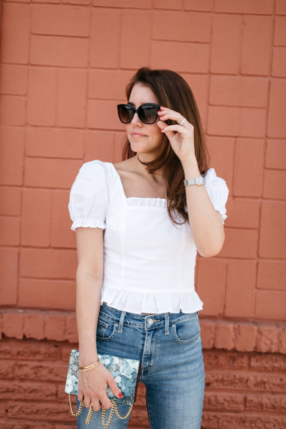 amy havins wears jeans and a white blouse.