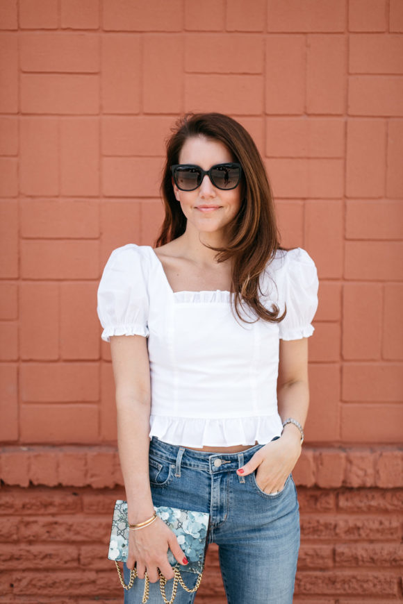 amy havins wears jeans and a white blouse.