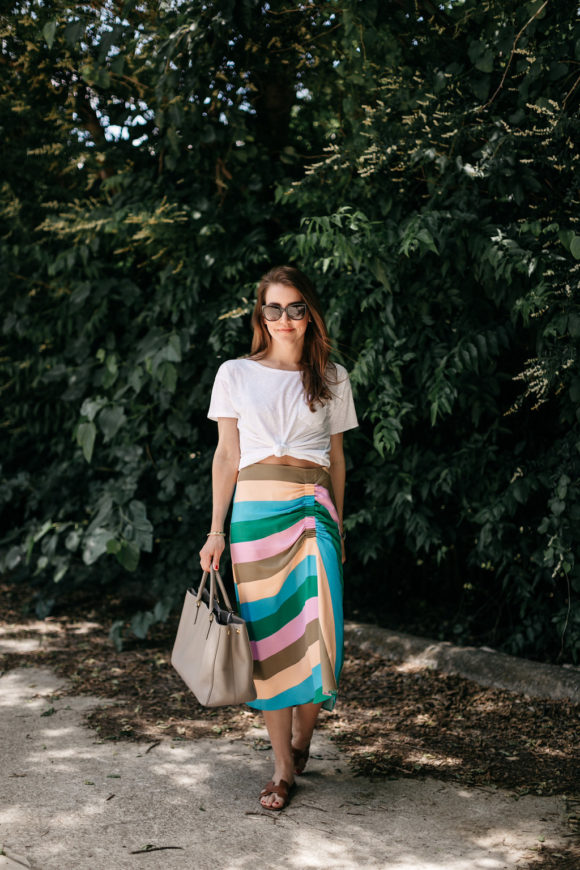Amy Havins wears a striped tibi skirt and white tee shirt.
