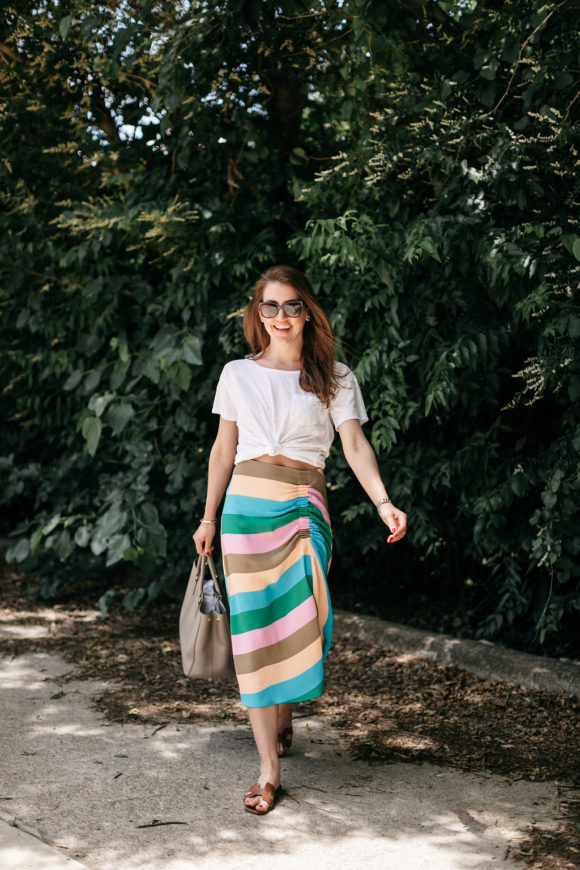 Amy Havins wears a striped tibi skirt and white tee shirt.