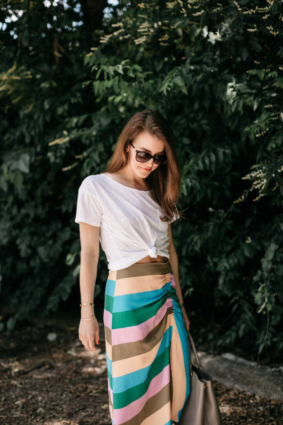 Amy Havins wears a striped tibi skirt and white tee shirt.