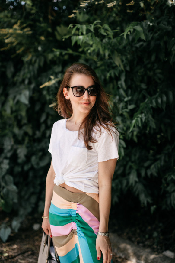 Amy Havins wears a striped tibi skirt and white tee shirt.