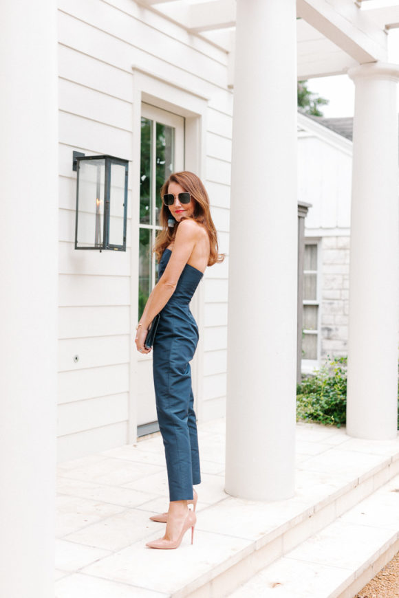 amy havins wears a navy jumpsuit