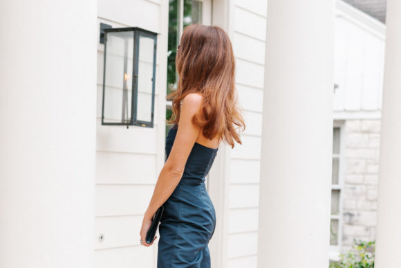 amy havins wears a navy jumpsuit