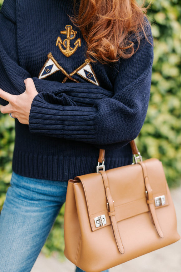 Amy havins wears a navy sweater and jeans.