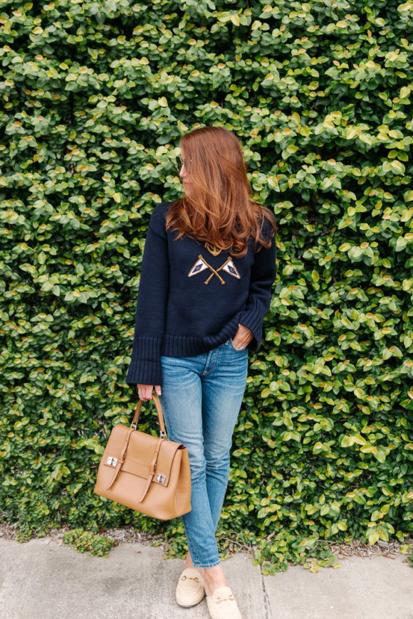 Amy havins wears a navy sweater and jeans.