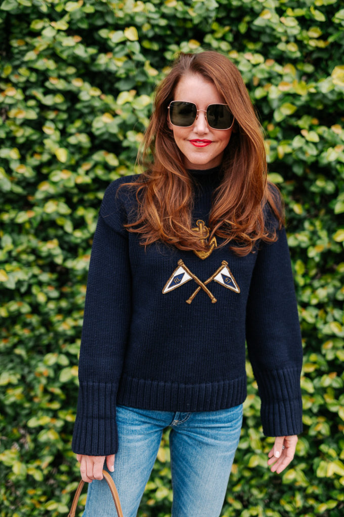 Amy havins wears a navy sweater and jeans.