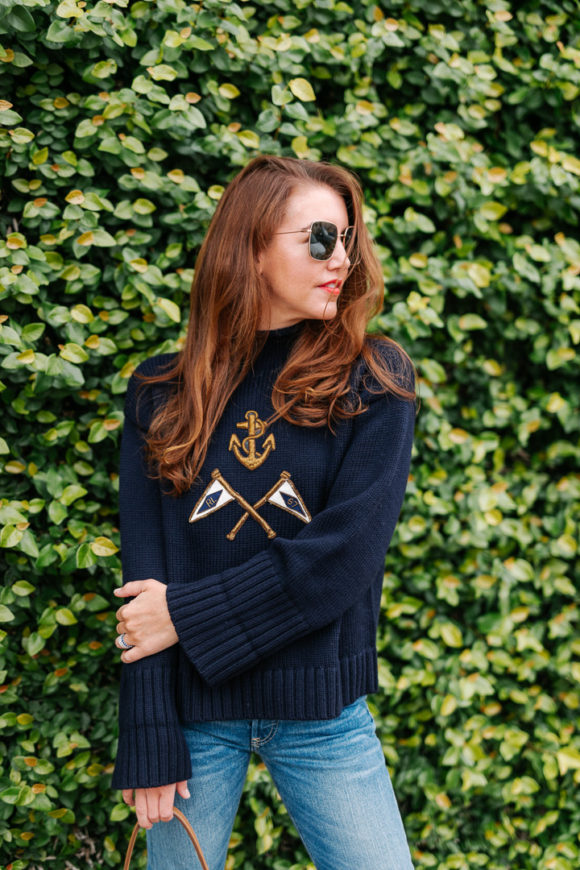 Amy havins wears a navy sweater and jeans.