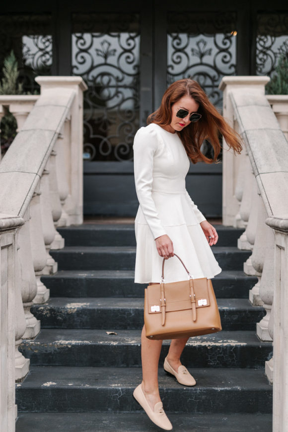 Amy Havins wears a white long sleeve dress.