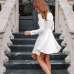 Amy Havins wears a white long sleeve dress.