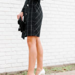 Amy Havins wears a black contrast plaid shoshanna dress.