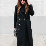 Amy Havins wears a black ralph lauren coat.