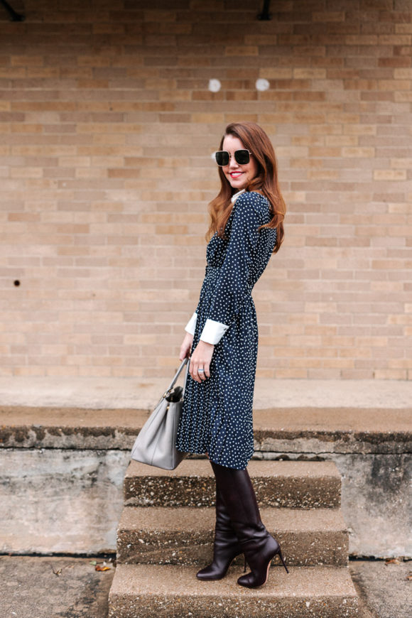 Amy Havins wears a navy polka dot dress