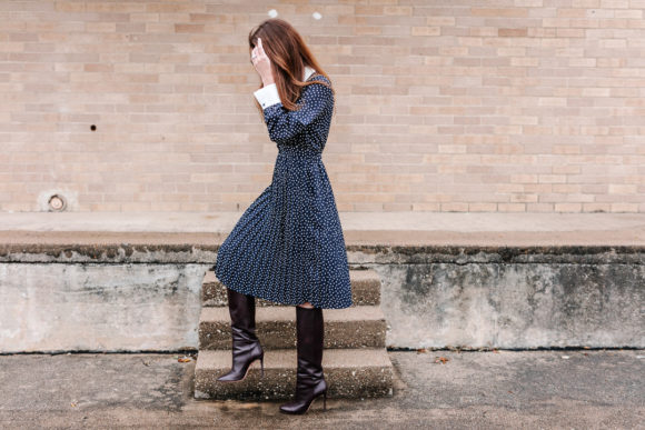 Amy Havins wears a navy polka dot dress