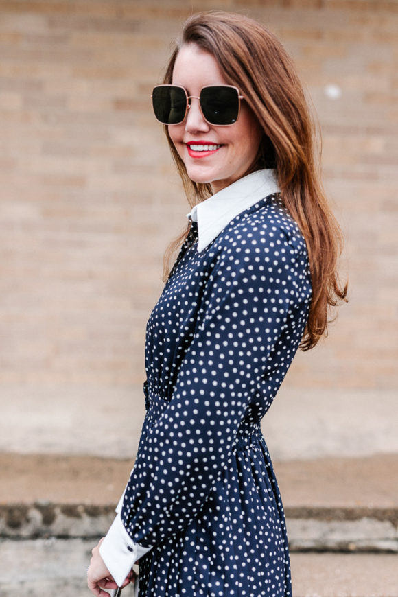 Amy Havins wears a navy polka dot dress