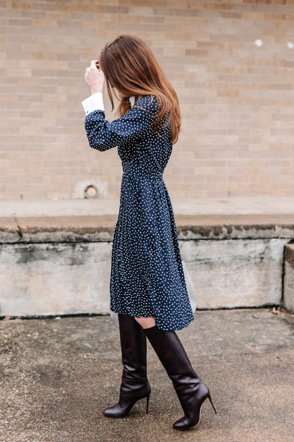 Amy Havins wears a navy polka dot dress