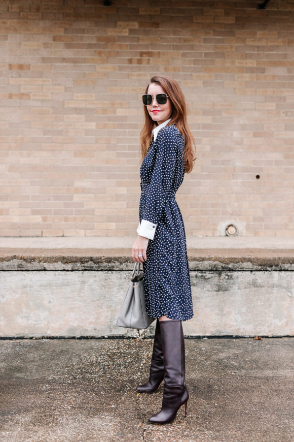 Amy Havins wears a navy polka dot dress