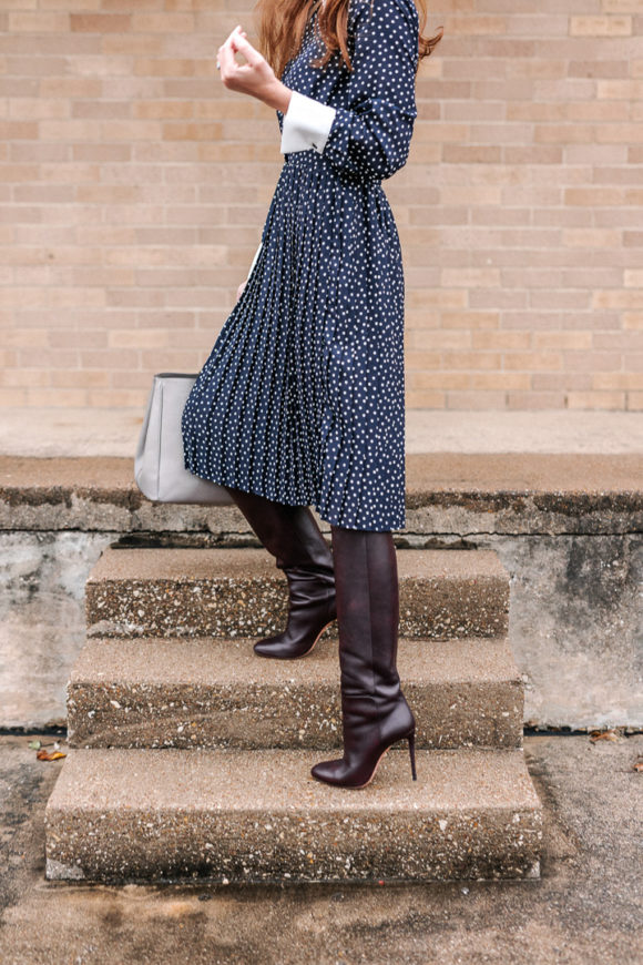 Amy Havins wears a navy polka dot dress