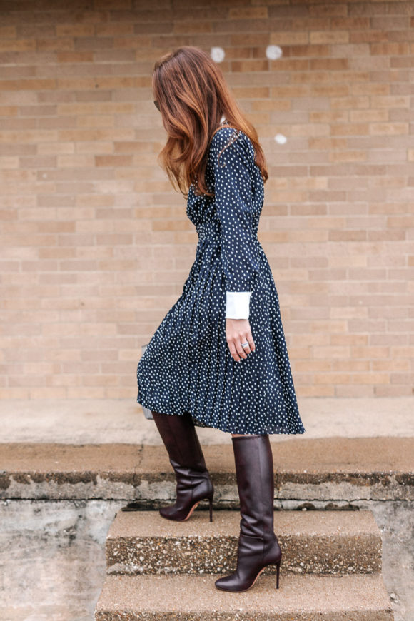 Amy Havins wears a navy polka dot dress